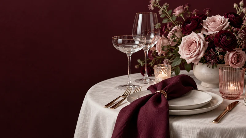 Original celebration still-life artwork with flowers, glassware and folded table linen